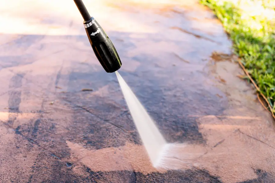 Person power washing driveway in sioux falls